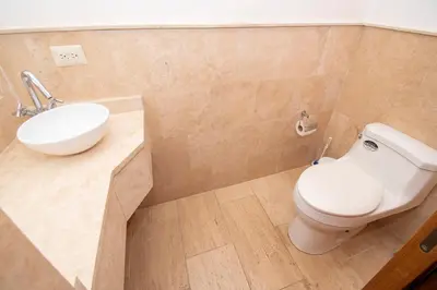 a bathroom with a white toilet and a sink at Apto en Casa de Campo en Los Altos 2 in La Romana