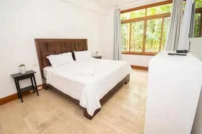 a bedroom with a white bed and a window at Apto en Casa de Campo en Los Altos 2 in La Romana