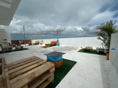a patio with a table and chairs on the beach at Apartment in Santo Domingo este in Juan López