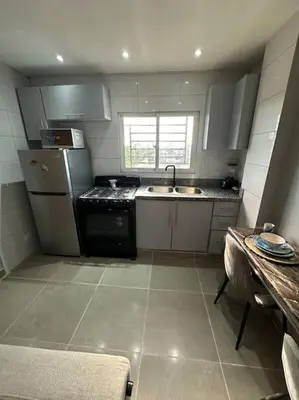 a small kitchen with a sink and a stove at Apartment in Santo Domingo este in Juan López