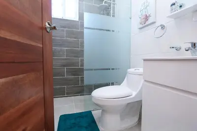 a bathroom with a toilet and a sink at Edificio Amber 1 in San Cristóbal