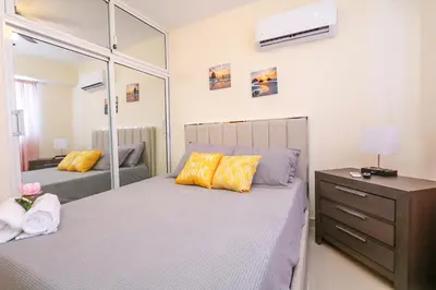 a bedroom with two beds and a mirror at Edificio Amber 1 in San Cristóbal