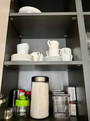 a shelf with plates and dishes and a coffee pot at AD-301 Ático Duplex Estrella Dominicus in La Laguna