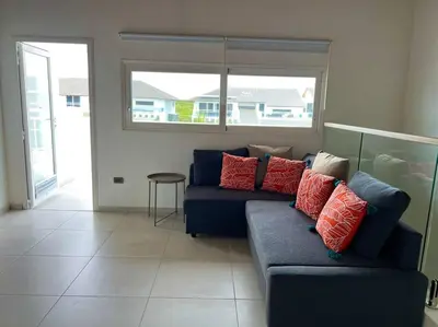 a living room with a blue couch with red pillows at AD-301 Ático Duplex Estrella Dominicus in La Laguna
