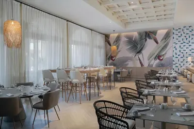 a dining room with tables and chairs and a mural at Dreams Playa Esmeralda Resort & Spa - All Inclusive in Miches