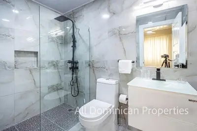 a bathroom with a shower and a toilet and a sink at Hill Side Condos - Hispaniola in Sosúa