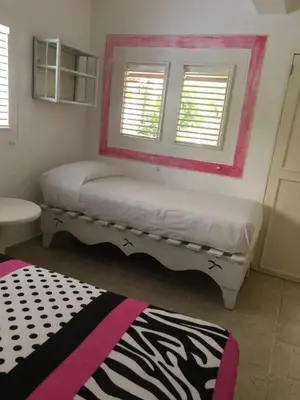 a bedroom with two beds and a mirror at Hotel Casa Robinson in Las Terrenas