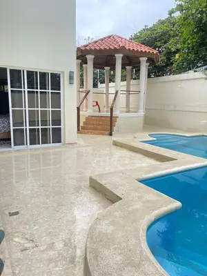 a house with a gazebo and a swimming pool at Villa familiar con vista al océano in San Felipe de Puerto Plata