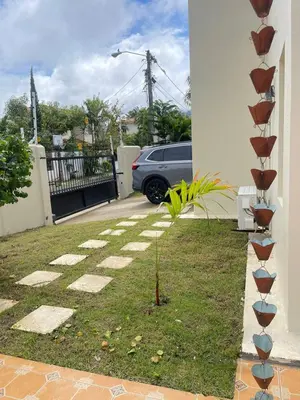a plant in a yard next to a house at Villa familiar con vista al océano in San Felipe de Puerto Plata