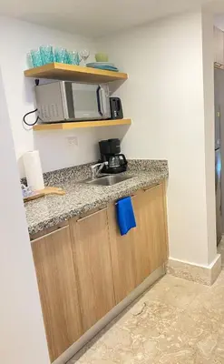 a kitchen with a sink and a microwave at Apartamento de playa in San Felipe de Puerto Plata