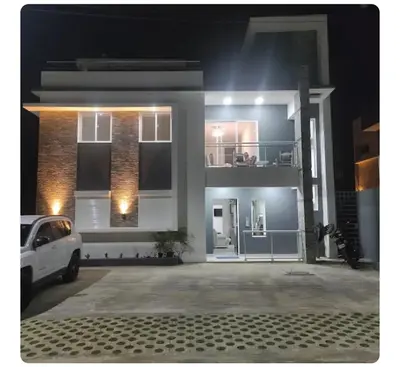 a white car parked in front of a house at night at Villa Vintage in Boca Chica