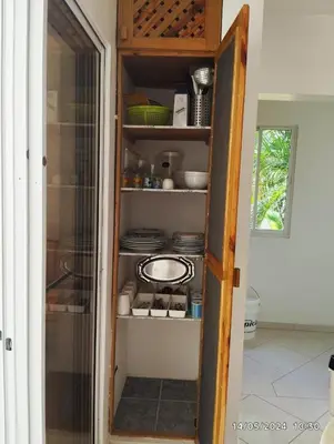 a pantry with a shelf with plates and dishes at Residencial caoba in Las Terrenas