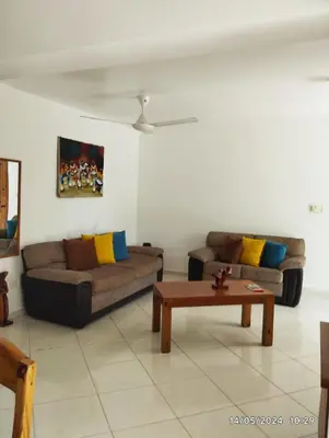 a living room with two couches and a coffee table at Residencial caoba in Las Terrenas