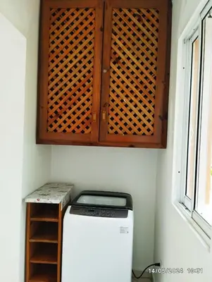 a wooden cabinet above a refrigerator in a kitchen at Residencial caoba in Las Terrenas