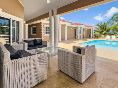 a villa with a swimming pool and a house at Casa Linda Club in Sosúa
