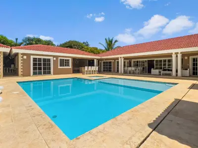 a swimming pool in front of a house at Casa Linda Club in Sosúa