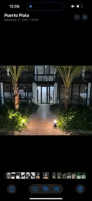 two palm trees in the middle of a building at New Beachfront at Sunset Apartments 3 Bedroom 2 Bath Gym Pool PS5 in San Felipe de Puerto Plata