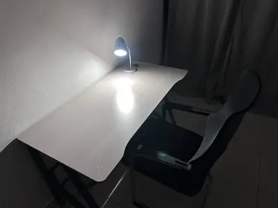a desk with a lamp on it with a chair at New Beachfront at Sunset Apartments 3 Bedroom 2 Bath Gym Pool PS5 in San Felipe de Puerto Plata