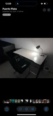 a computer screen with a table and a lamp on it at New Beachfront at Sunset Apartments 3 Bedroom 2 Bath Gym Pool PS5 in San Felipe de Puerto Plata