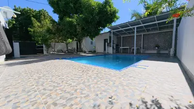 a swimming pool in the backyard of a house at Villa Cordero - Las Calderas Bani in Baní