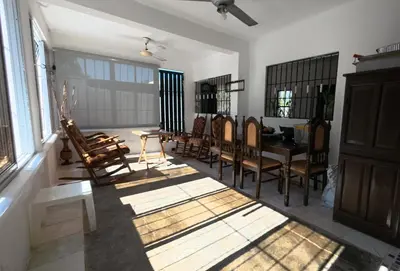 a living room with a table and chairs at Villa Cordero - Las Calderas Bani in Baní