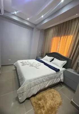 a bedroom with a large bed and a window at Apartamento santo domingo este in Juan López