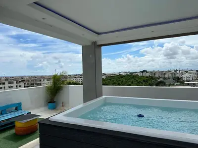 a hot tub on a balcony with a view at Apartamento santo domingo este in Juan López