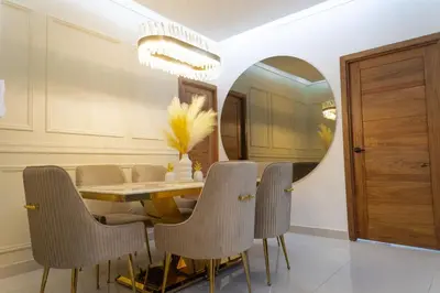 a dining room with a table and chairs and a mirror at Apartamento en el gran santo Domingo in Santo Domingo