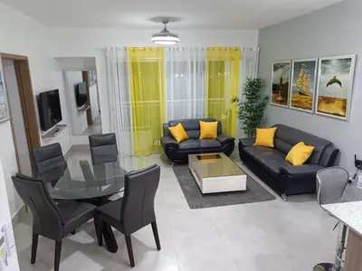 a living room with a couch and a table at Boca del Mar III, apartamento 706A in Boca Chica