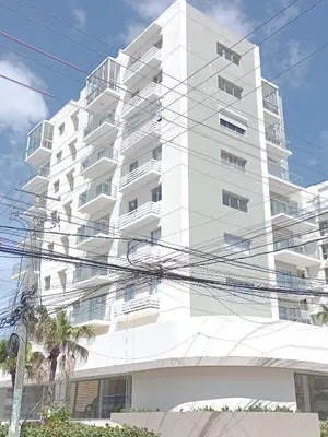 a tall white building with power lines in front of it at Boca del Mar III, apartamento 706A in Boca Chica