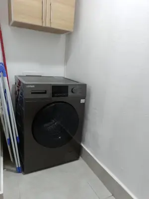 a black washing machine in a corner of a room at Boca del Mar III, apartamento 706A in Boca Chica
