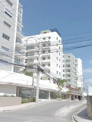 an empty street in front of a tall white building at Boca del Mar III, apartamento 706A in Boca Chica