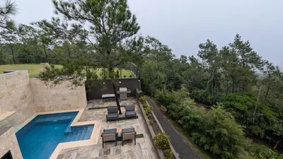 an aerial view of a house with a swimming pool at The Grand Forest Jarabacoa in Jarabacoa