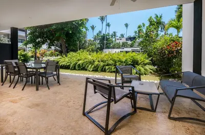 a group of chairs and tables in a patio at Aligio Aparthotel, Beachfront, Las Terrenas in Las Terrenas