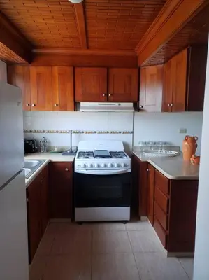 a kitchen with a black and white stove top oven at Apartamento Corozos 2-202 in Paraíso