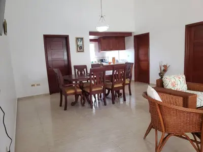 a living room with a dining room table and chairs at Apartamento Corozos 2-202 in Paraíso