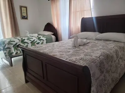 a stuffed animal is sitting on a bed at Apartamento Corozos 2-202 in Paraíso