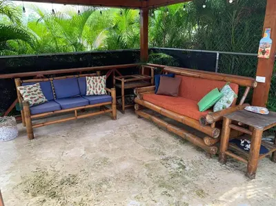 two chairs and a couch on a patio at Villa en boca chica in Cuevas