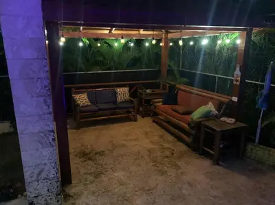 a room with two couches and a table and lights at Villa en boca chica in Cuevas
