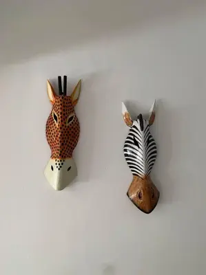 a group of three ceramic animal heads on a wall at Villa en boca chica in Cuevas
