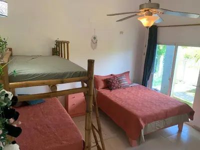 a bedroom with two bunk beds and a window at Villa en boca chica in Cuevas