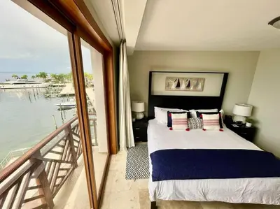 a bedroom with a bed with a view of the water at Hotel en Samana con vista al Mar in Sabana