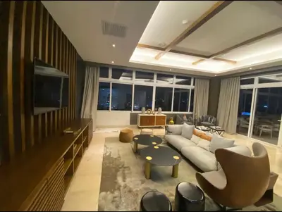 a living room with a couch and a tv at PiantiniTowerCentric SDQ CityView in Santo Domingo