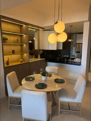 a dining room with a table and chairs and a kitchen at Arpel 6 SantoDomingo CItySeaView in Santo Domingo