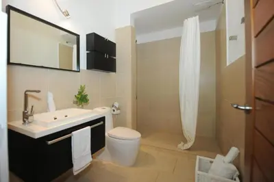 a bathroom with a sink and a toilet and a shower at Infiniti Blu in Sosúa