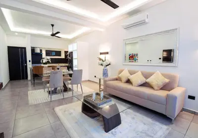 a living room with a couch and a table at Infiniti Blu in Sosúa