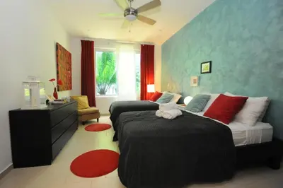 a bedroom with two beds and a dresser at Infiniti Blu in Sosúa