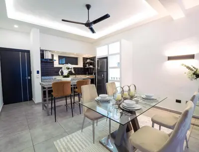 a dining room and kitchen with a table and chairs at Infiniti Blu in Sosúa