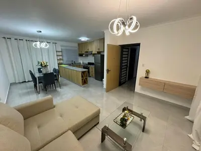 a living room and kitchen with a couch and a table at RESIDENCIAL LEGADO Apto 1 A in Azua