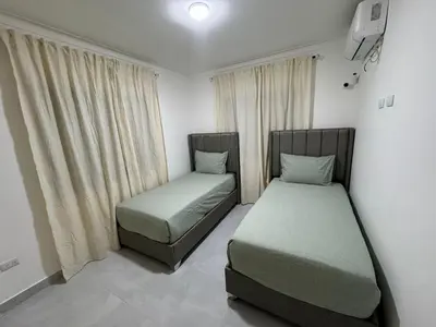 two beds sitting in a room with curtains at RESIDENCIAL LEGADO Apto 1 A in Azua
